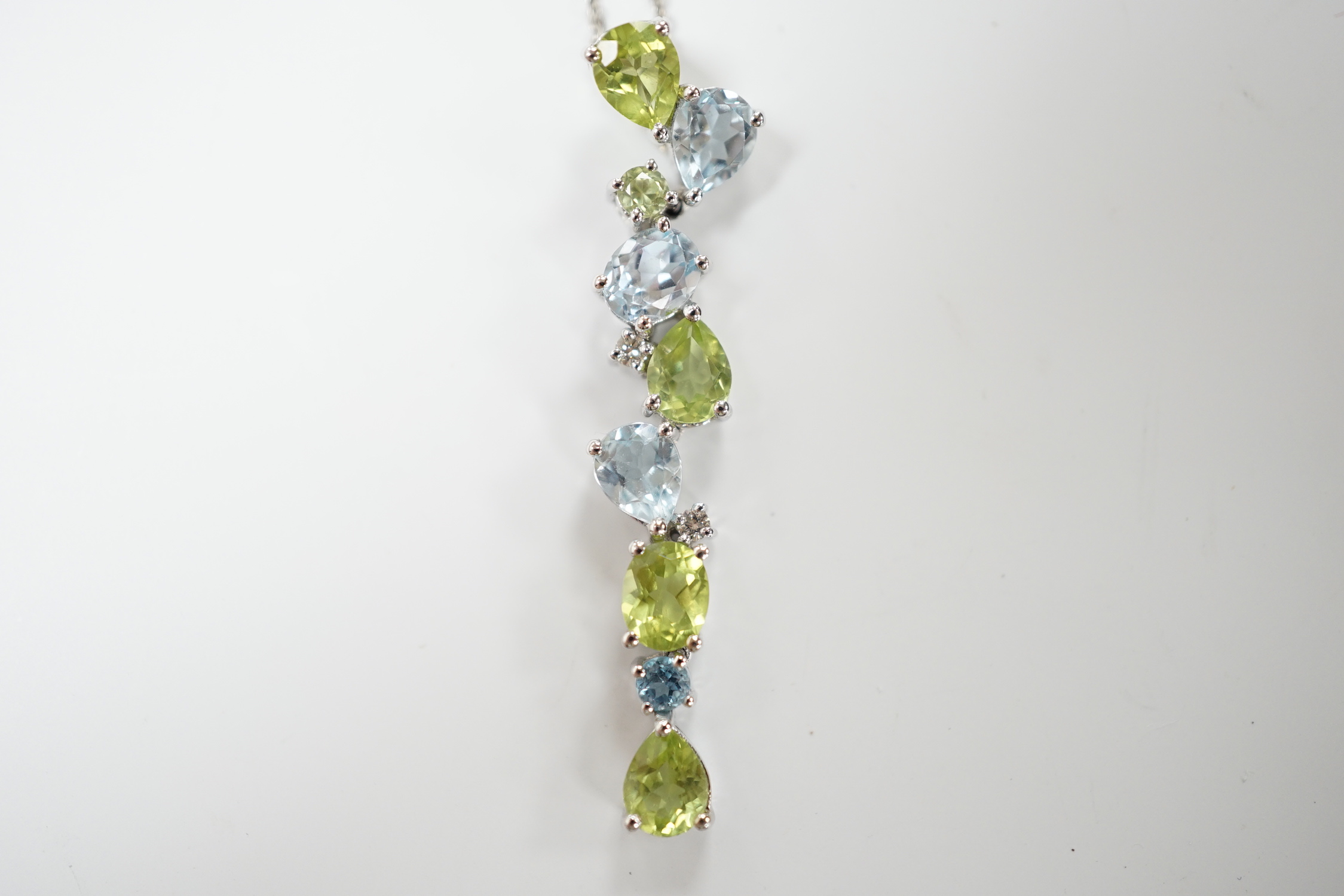 A modern 9ct white gold, peridot and blue topaz set pendant, 37mm, on a 375 chain, 40cm, gross weight 3.4 grams.